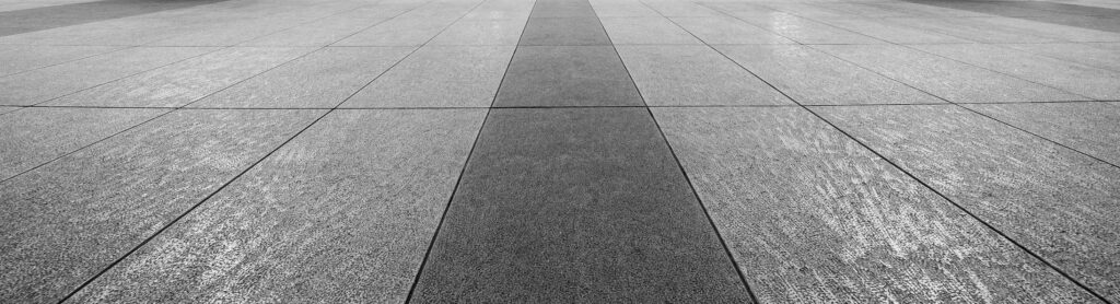 Perspective View of Monotone Gray Brick Stone on The Ground for Street Road. Sidewalk, Driveway, Pavers, Pavement in Vintage Design Flooring Square Pattern Texture Background